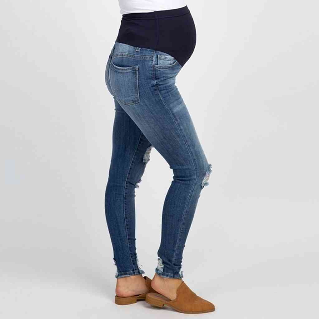 Pantaloni / pantaloni di maternità dei jeans strappati della donna incinta