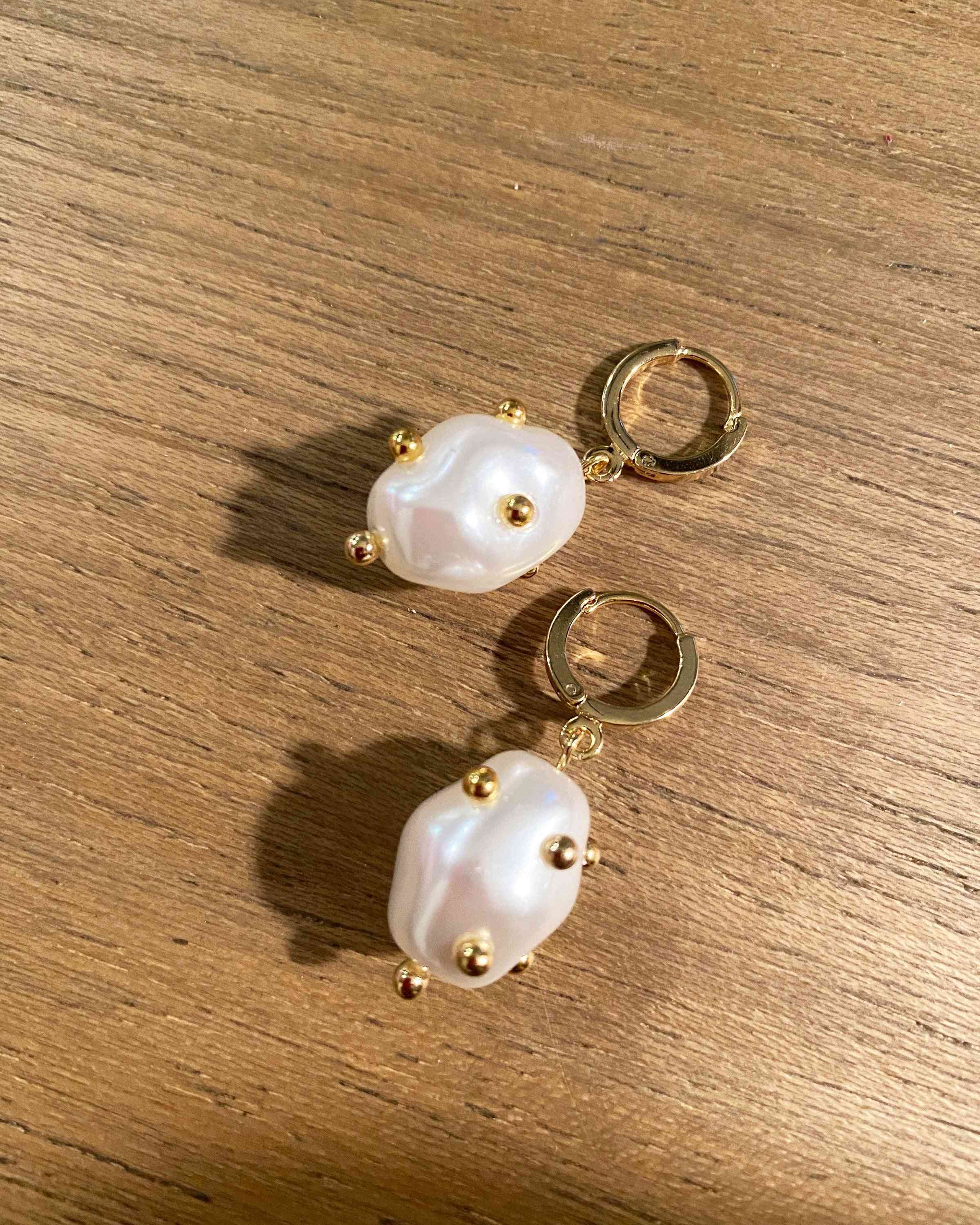 Clara Pearly White Huggie Earrings